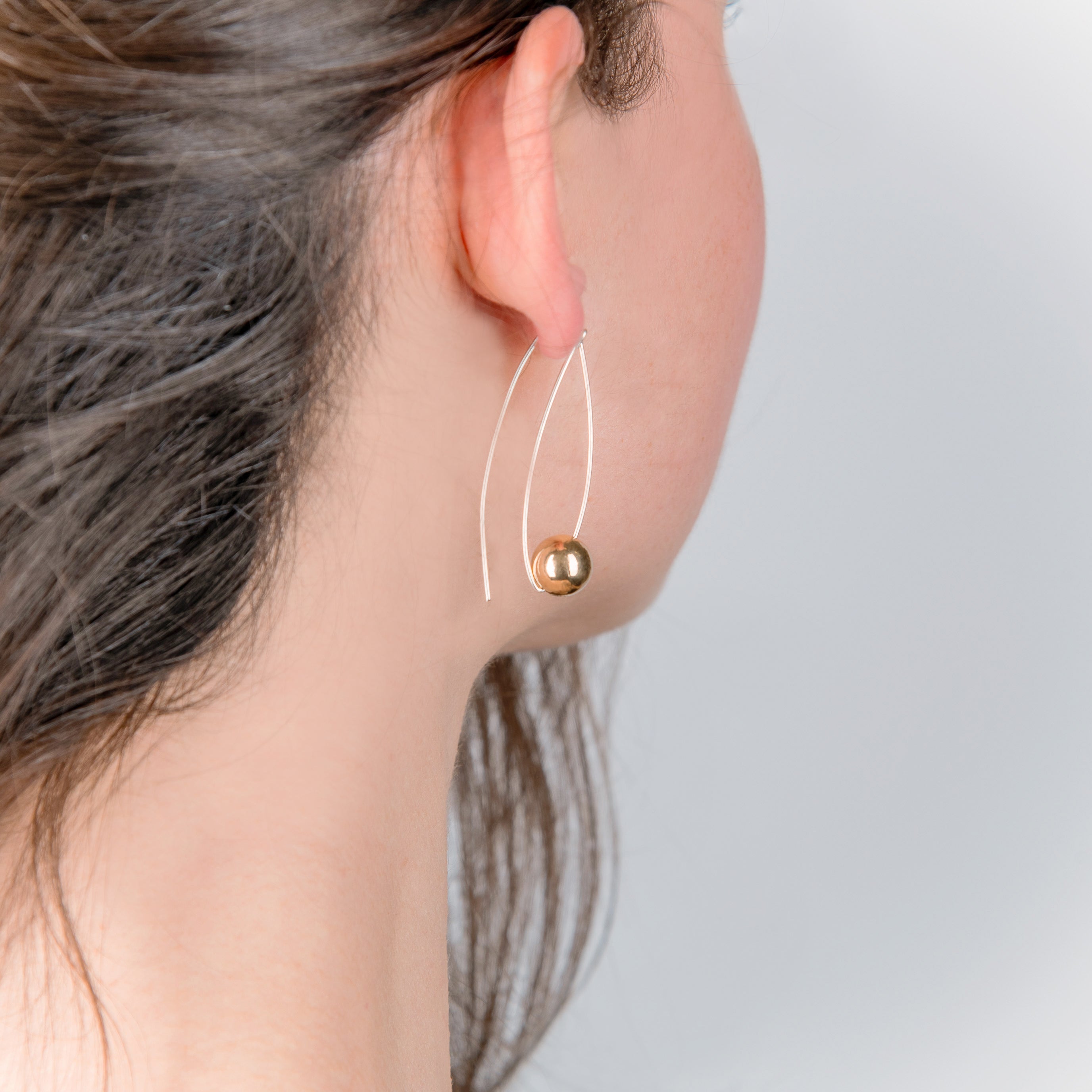 silver long hook with gold suspended ball