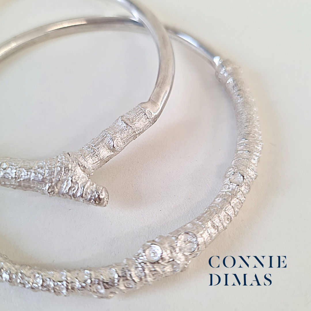 silver bangles with twig textures and smooth lines. Australian inspired.