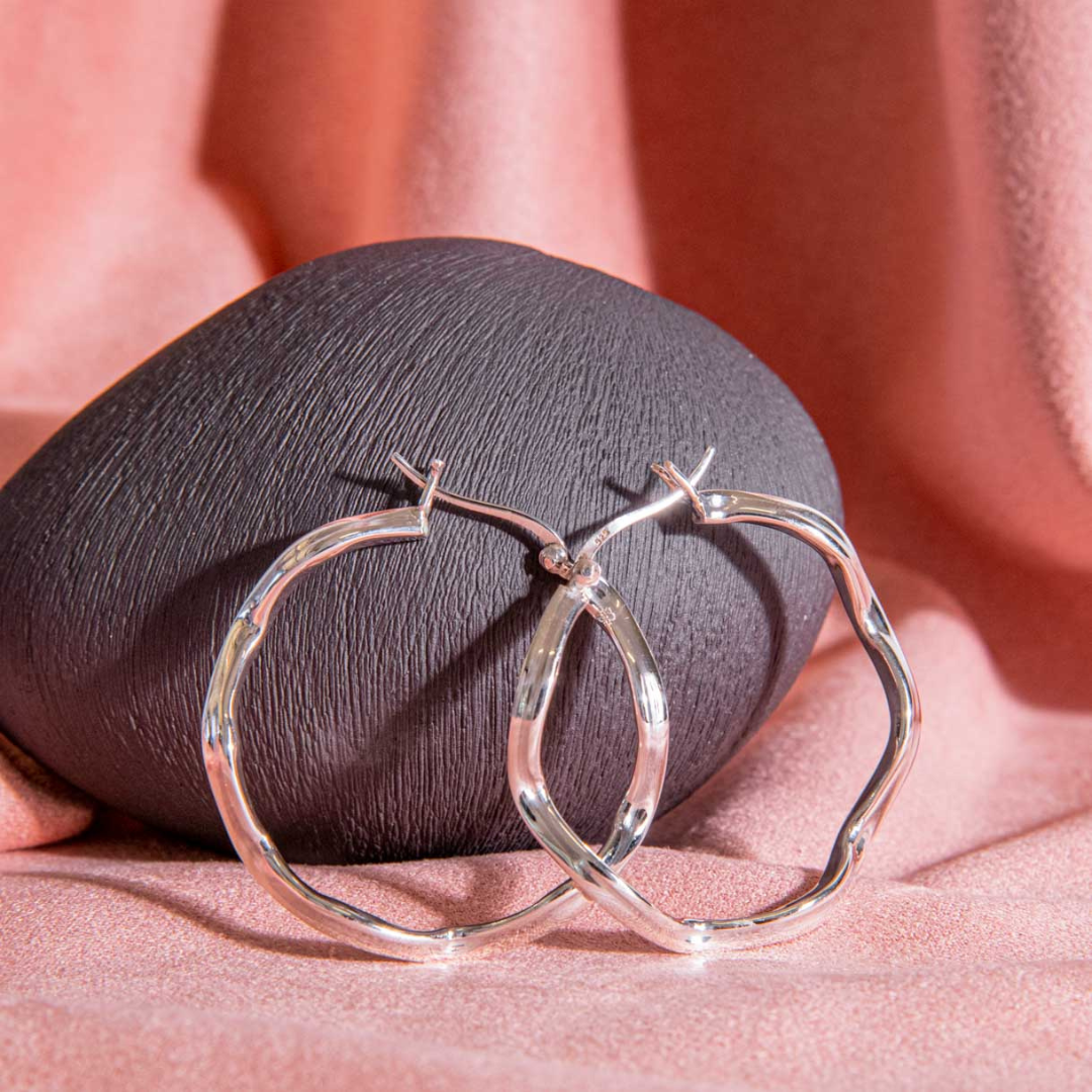 silver hoop earring, curvy modern shape polished for women