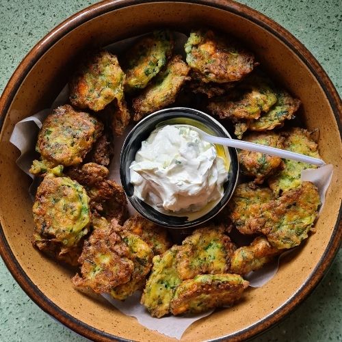Greek cooking zucchini fritters with wine and garlic sauce. Party food